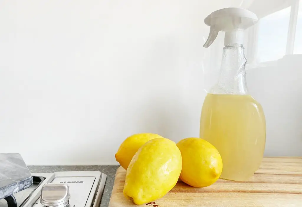 yellow lemon fruit beside clear glass bottle