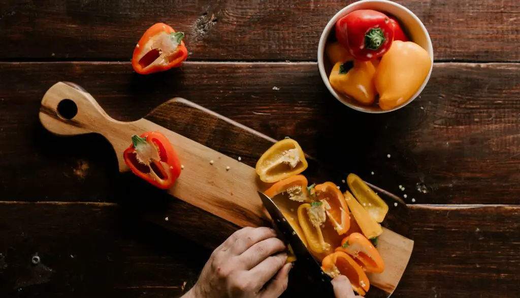 person slicing peppers