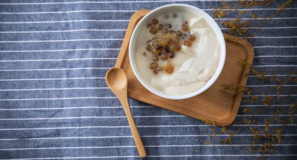 white ceramic bowl with brown wooden spoon