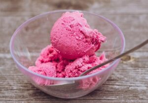 strawberry ice cream in clear glass bowl