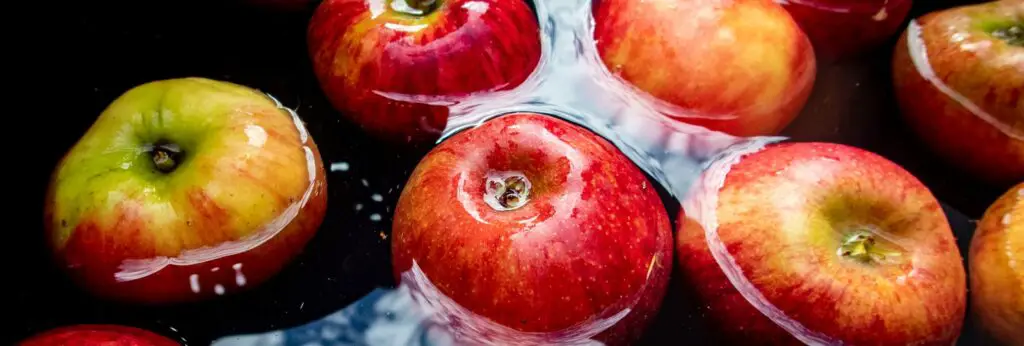 red and yellow apples floating on water