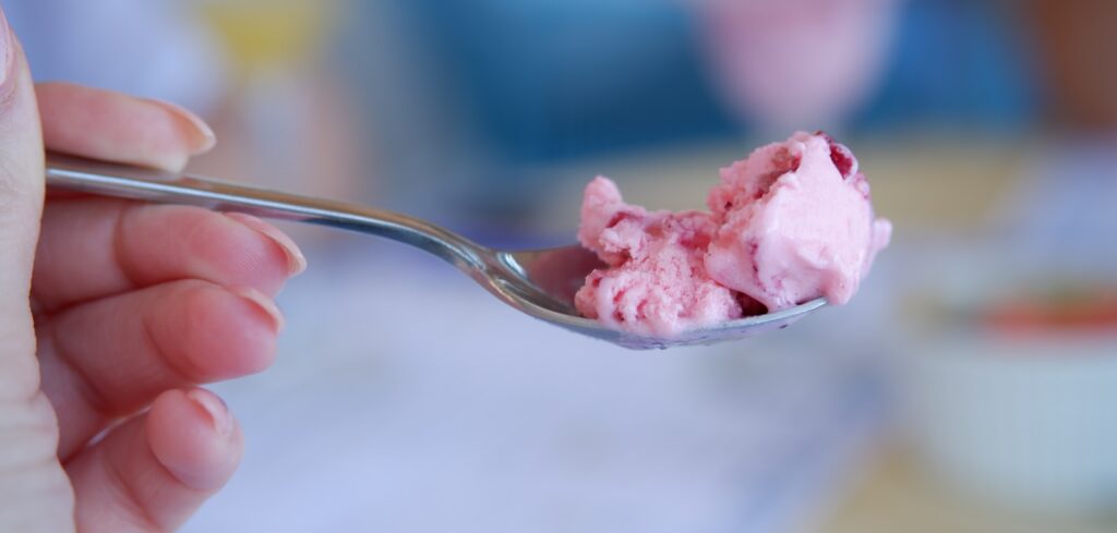 pink ice cream in clear glass cup