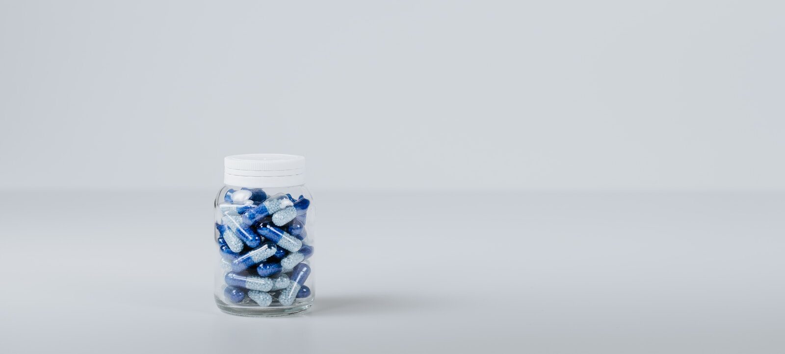 blue and white tablet in container